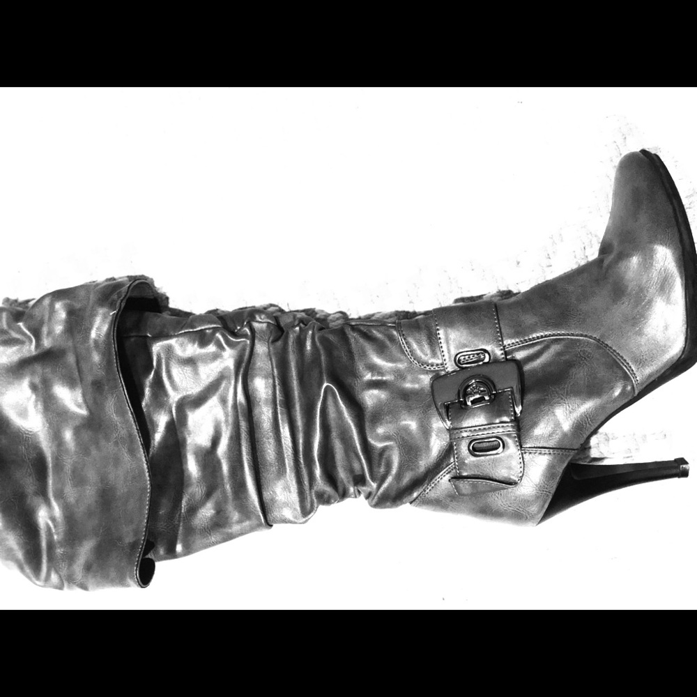 Hi heeled gray knee boots.